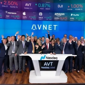 A group of people standing in front of a screen.