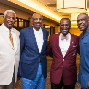 Four men in suits and ties posing for a picture.