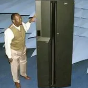 A man standing next to an open refrigerator.