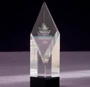 A crystal award on top of a table.