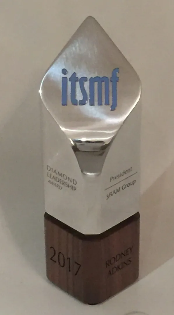 A glass trophy with the words " itsmf " on it.