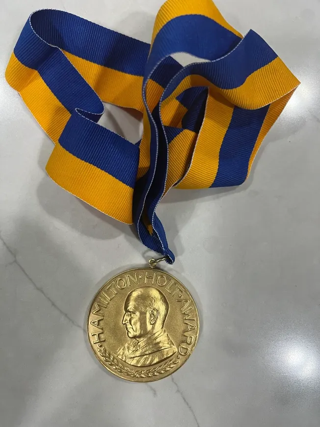 A gold medal sitting on top of a table.
