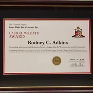 A framed certificate of achievement for the laurel wreath award.