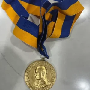 A gold medal sitting on top of a table.