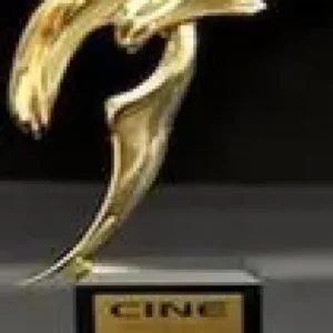 A gold statue of a bird on top of a black and silver pedestal.